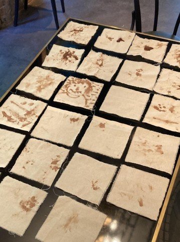 Cloth napkins marked with cacao and vanilla laid out on a table