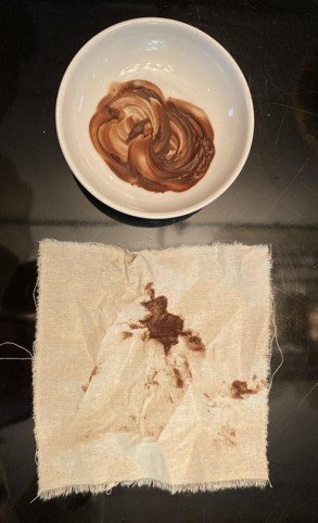 A bowl of mixed cacao and vanilla above a marked cloth napkin